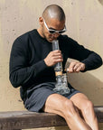 Man using 16” voyager ufo bong Vitae Glass.